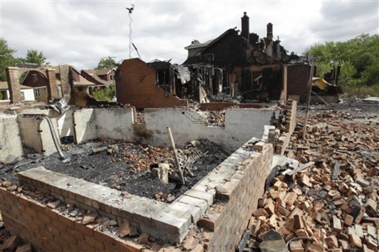 Wind-whipped flames swept through at least three Detroit neighborhoods on Tuesday, destroying dozens of homes, including many that were vacant, officials said.